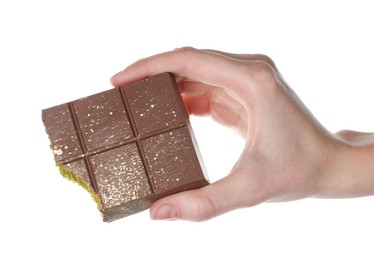 Photo of Woman holding piece of Dubai chocolate bar with pistachio and knafeh on white background, closeup