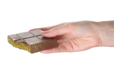 Photo of Woman holding piece of Dubai chocolate bar with pistachio and knafeh on white background, closeup