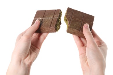 Photo of Woman breaking Dubai chocolate bar with pistachio and knafeh on white background, closeup