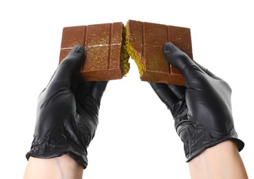 Photo of Woman breaking Dubai chocolate bar with pistachio and knafeh on white background, closeup