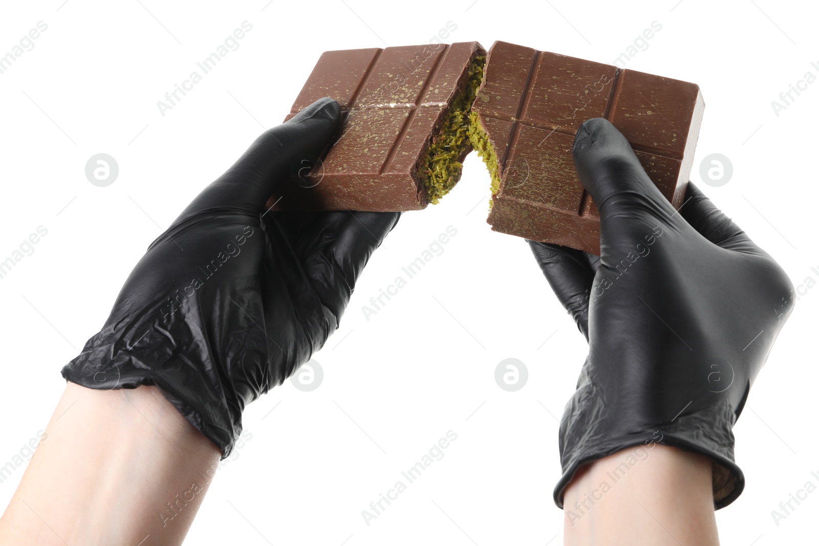 Photo of Woman breaking Dubai chocolate bar with pistachio and knafeh on white background, closeup