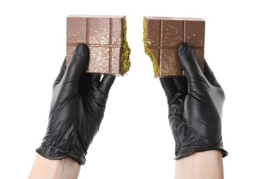 Photo of Woman breaking Dubai chocolate bar with pistachio and knafeh on white background, closeup