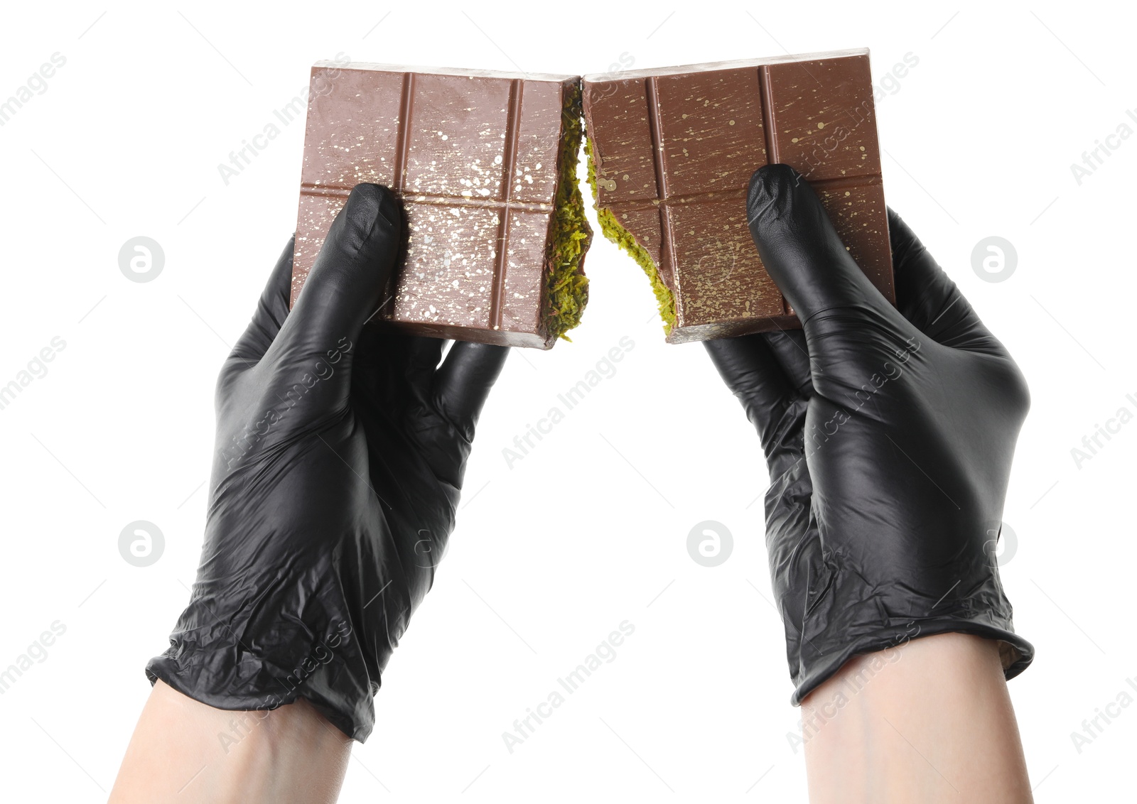 Photo of Woman breaking Dubai chocolate bar with pistachio and knafeh on white background, closeup