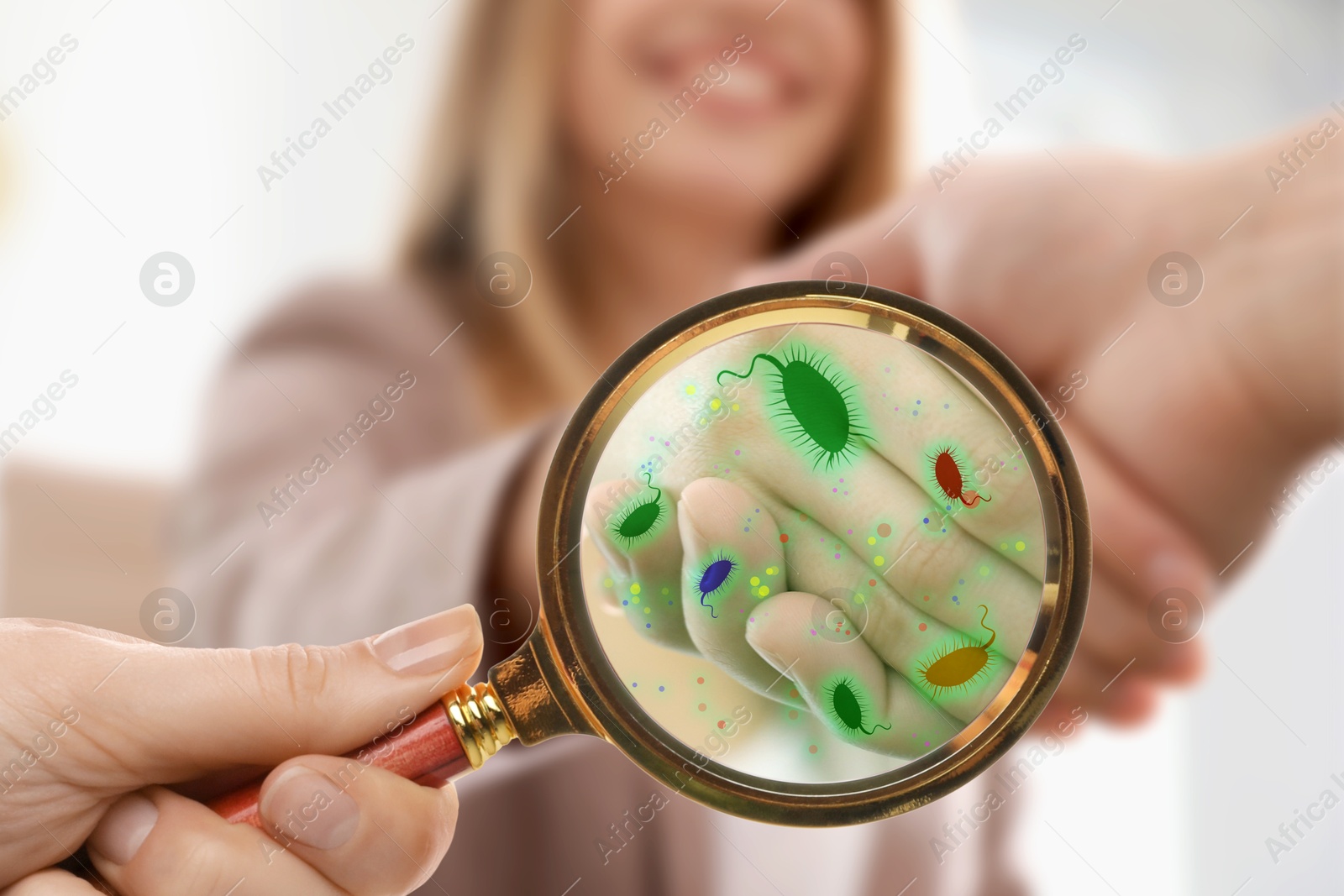 Image of People shaking hands, closeup. Pathogens transmission, illustration of microbes. View through magnifying glass