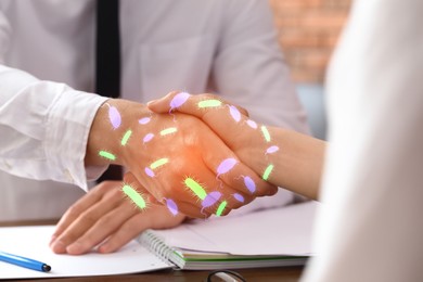 People shaking hands, closeup. Pathogens transmission, illustration of microbes