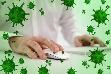 Image of Man using computer mouse at table, closeup. Pathogens transmission, illustration of microbes