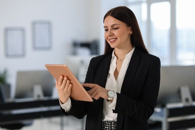 Photo of Banker using tablet in office, space for text