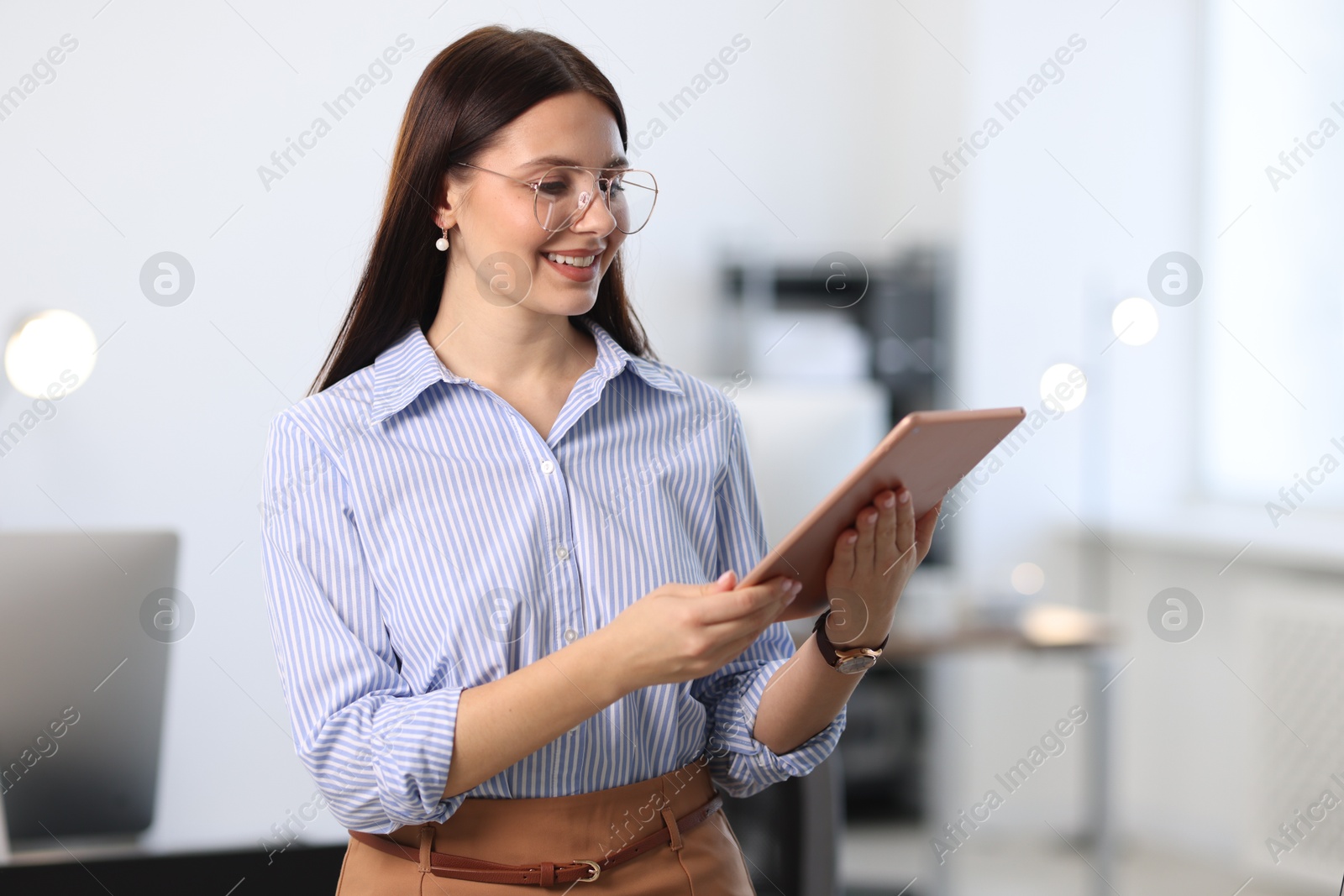 Photo of Portrait of banker using tablet in office