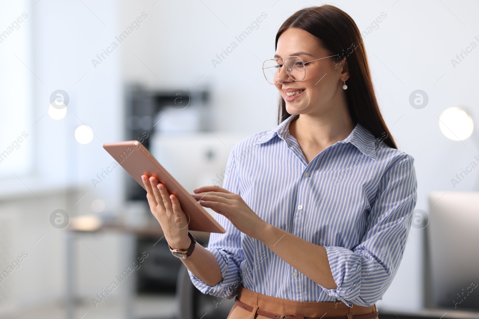 Photo of Portrait of banker using tablet in office