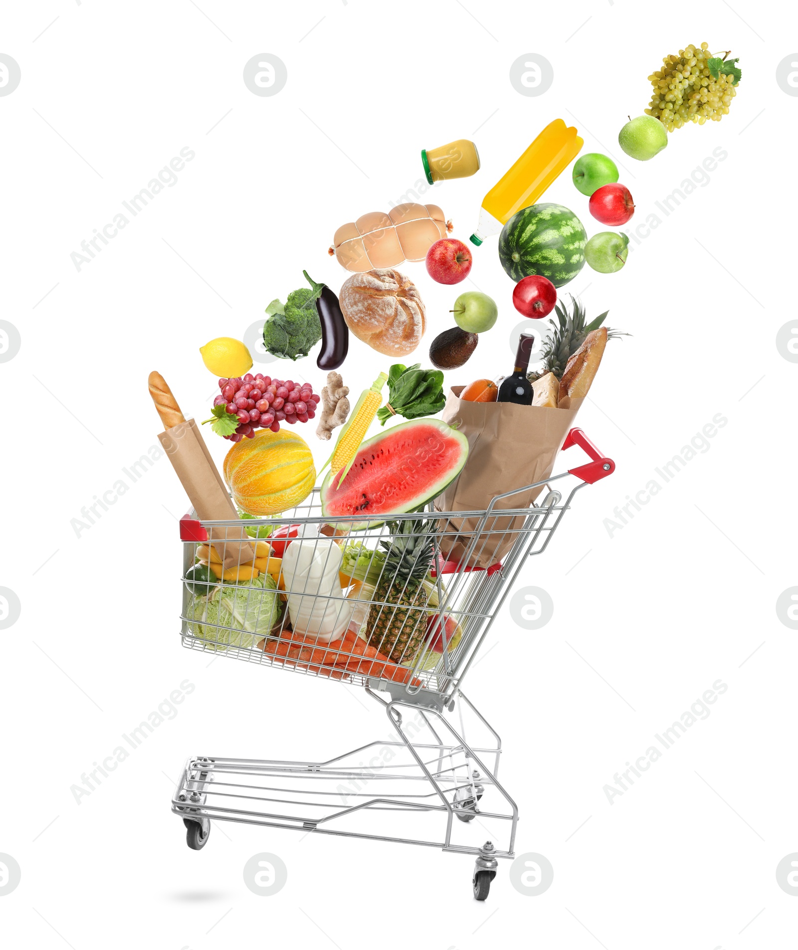 Image of Many different products falling into shopping cart on white background