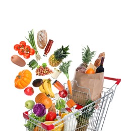 Image of Many different products falling into shopping cart on white background