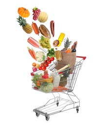 Image of Many different products falling into shopping cart on white background