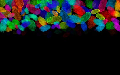 Image of Fingerprints of different colors on black background, space for text