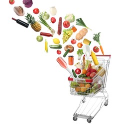 Image of Many different products falling into shopping cart on white background