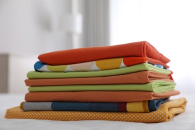 Photo of Clean color folded linens on bed indoors