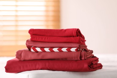 Photo of Clean color folded linens on bed indoors