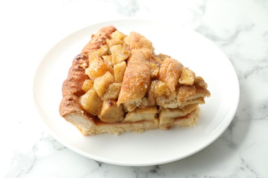 Photo of Slice of homemade apple pie on white marble table