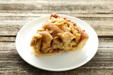 Photo of Slice of homemade apple pie on wooden table