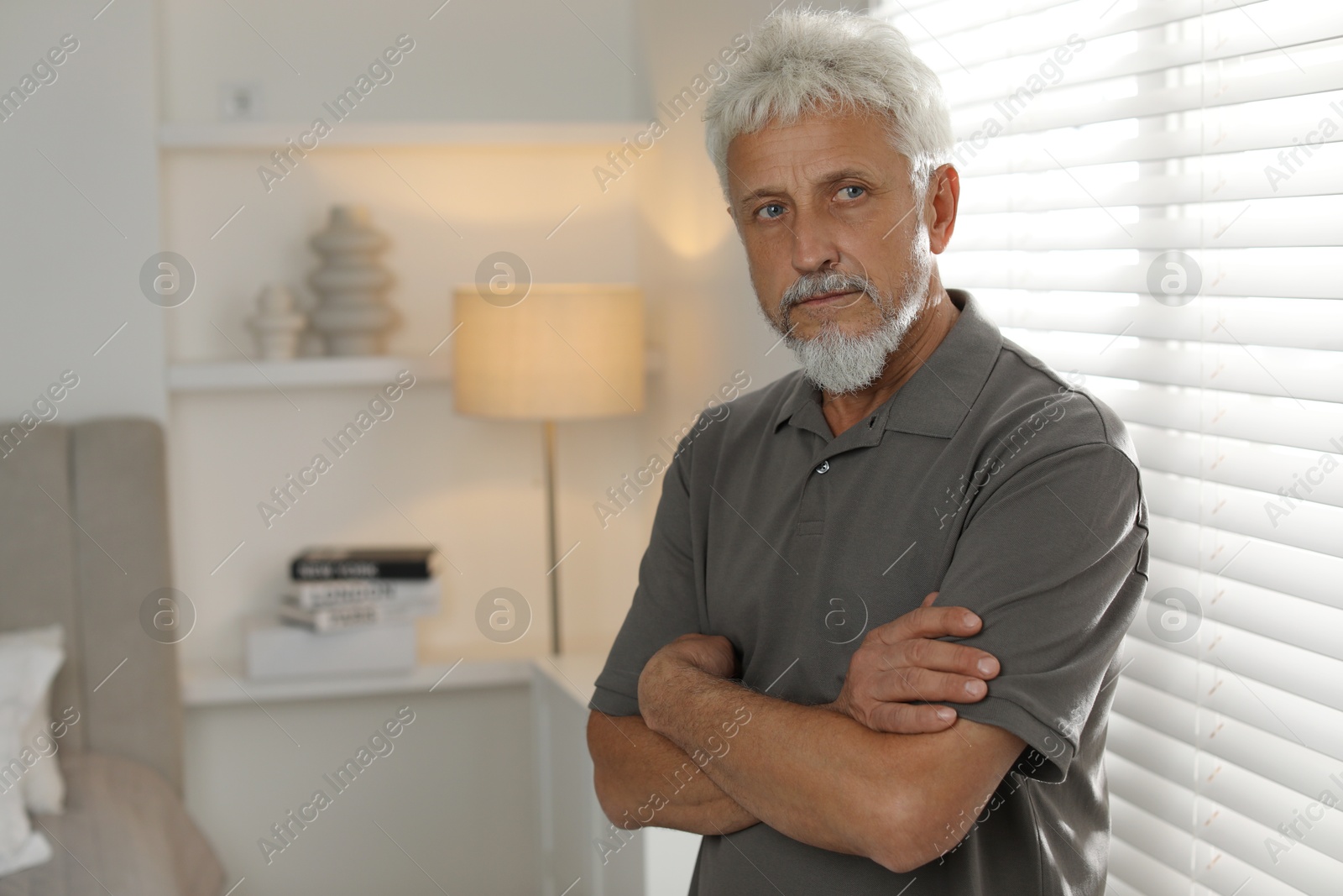 Photo of Sad senior man feeling lonely at home