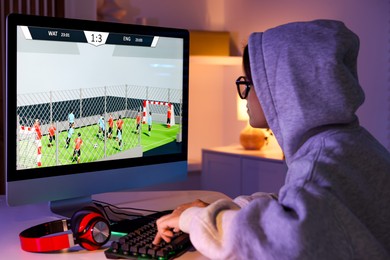 Photo of Woman playing video game with keyboard at table indoors