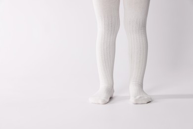 Photo of Child wearing tights on white background, closeup. Space for text