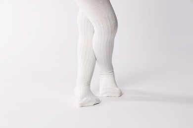 Photo of Child wearing tights on white background, closeup