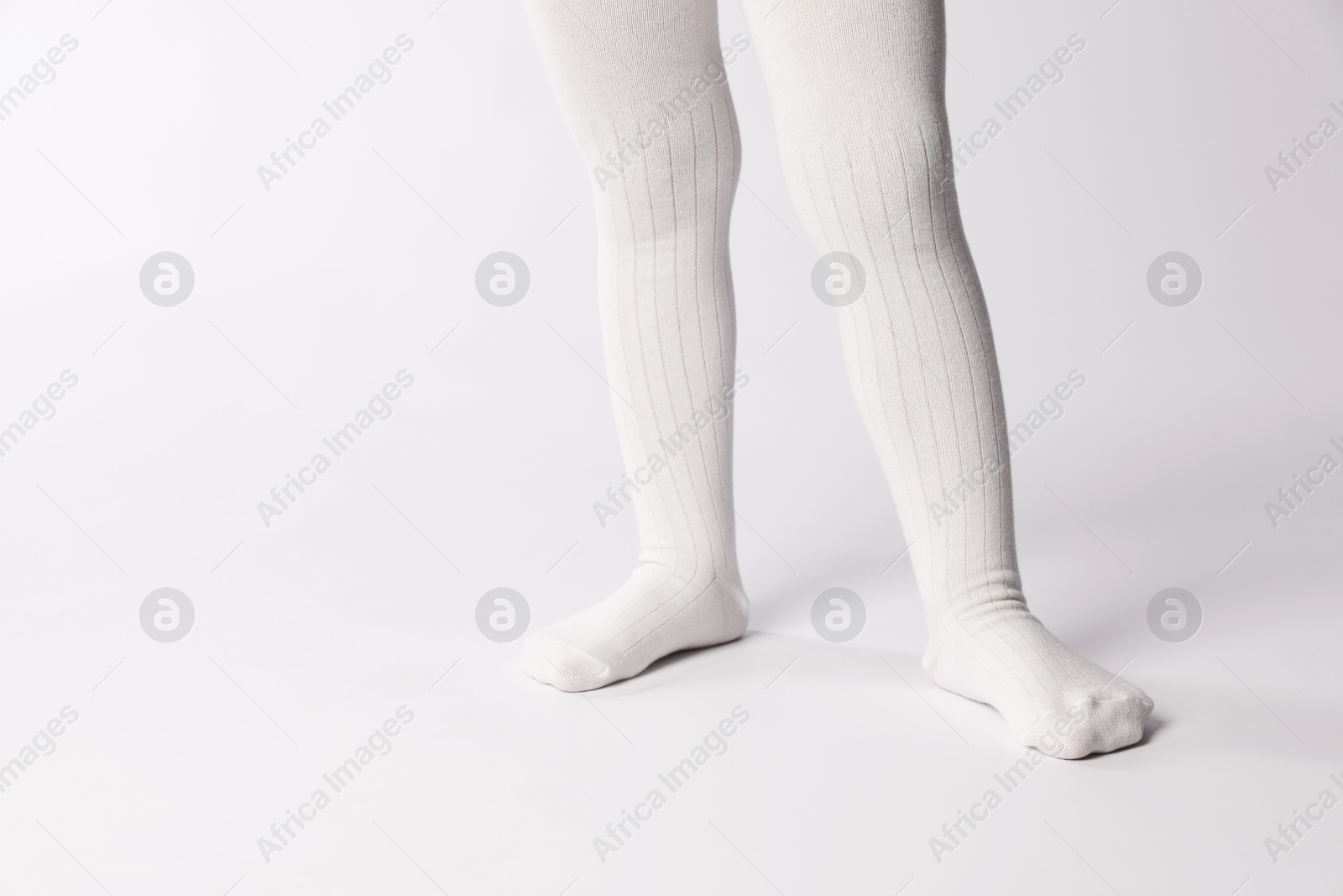 Photo of Child wearing tights on white background, closeup. Space for text