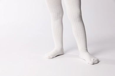 Photo of Child wearing tights on white background, closeup. Space for text