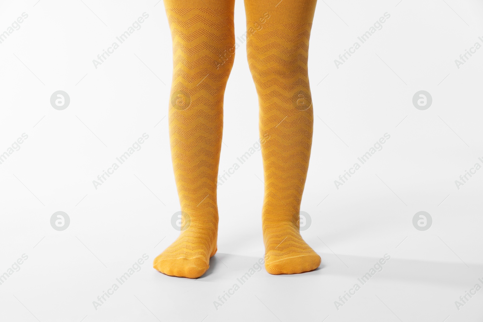 Photo of Child wearing bright tights on white background, closeup