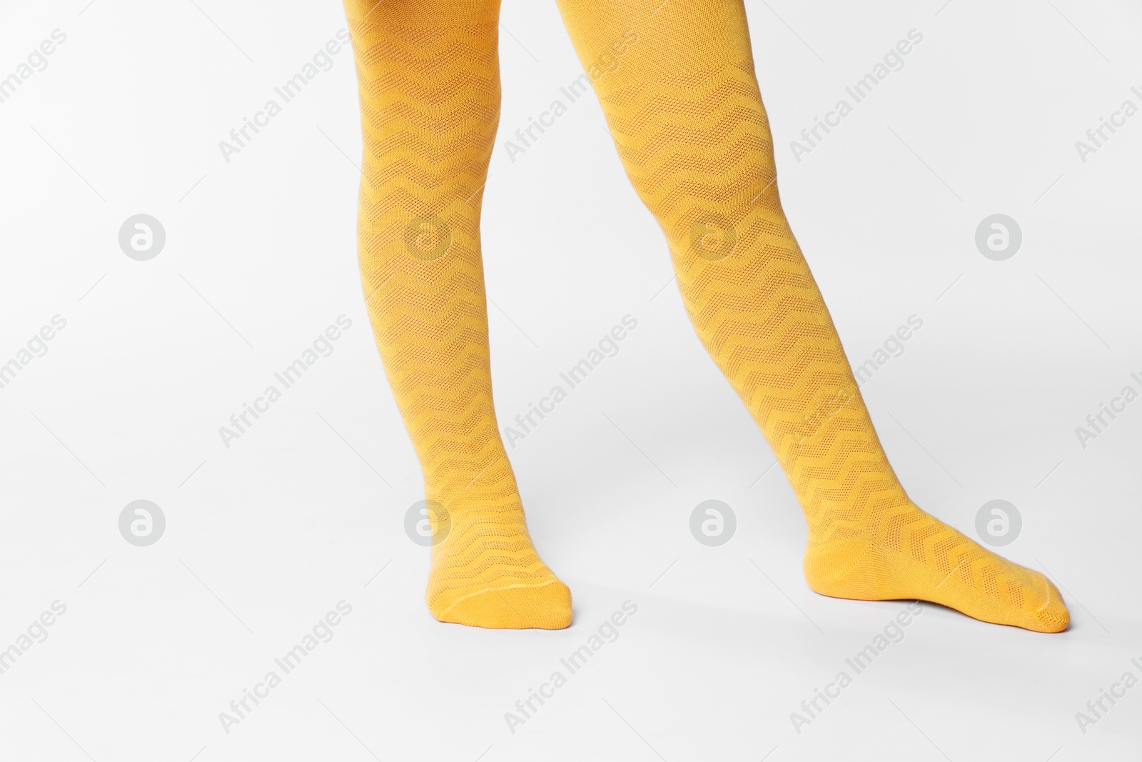 Photo of Child wearing bright tights on white background, closeup