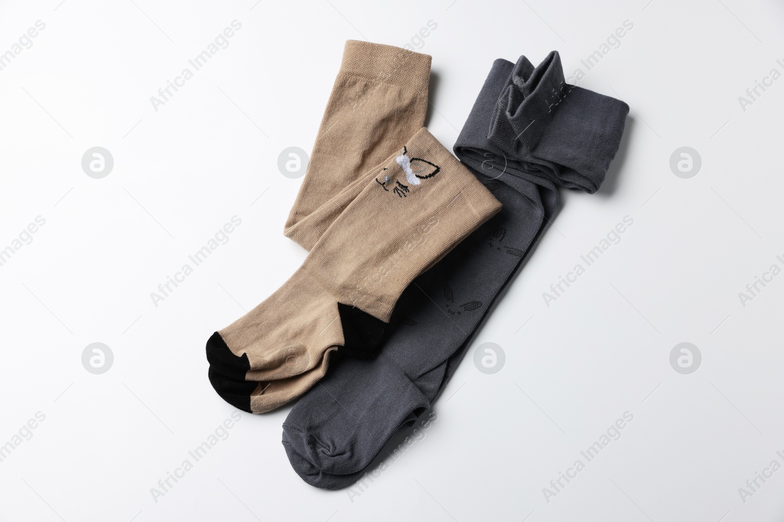 Photo of Different child's tights on white background, top view