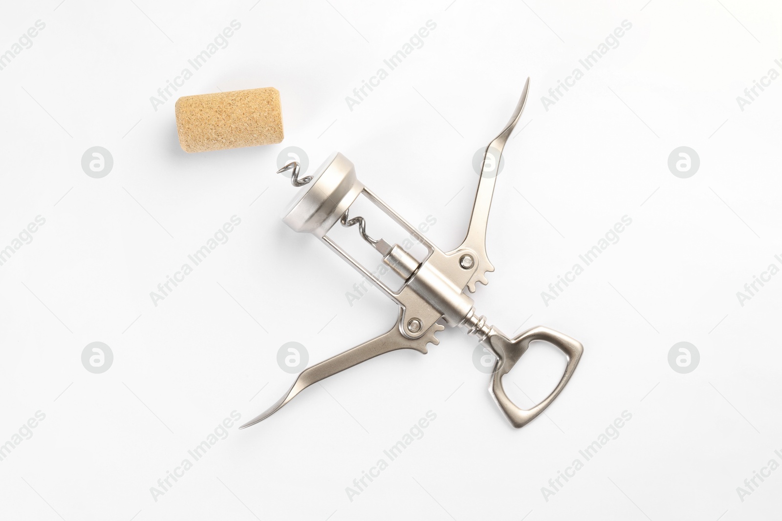 Photo of Wing corkscrew and cork on white background, top view