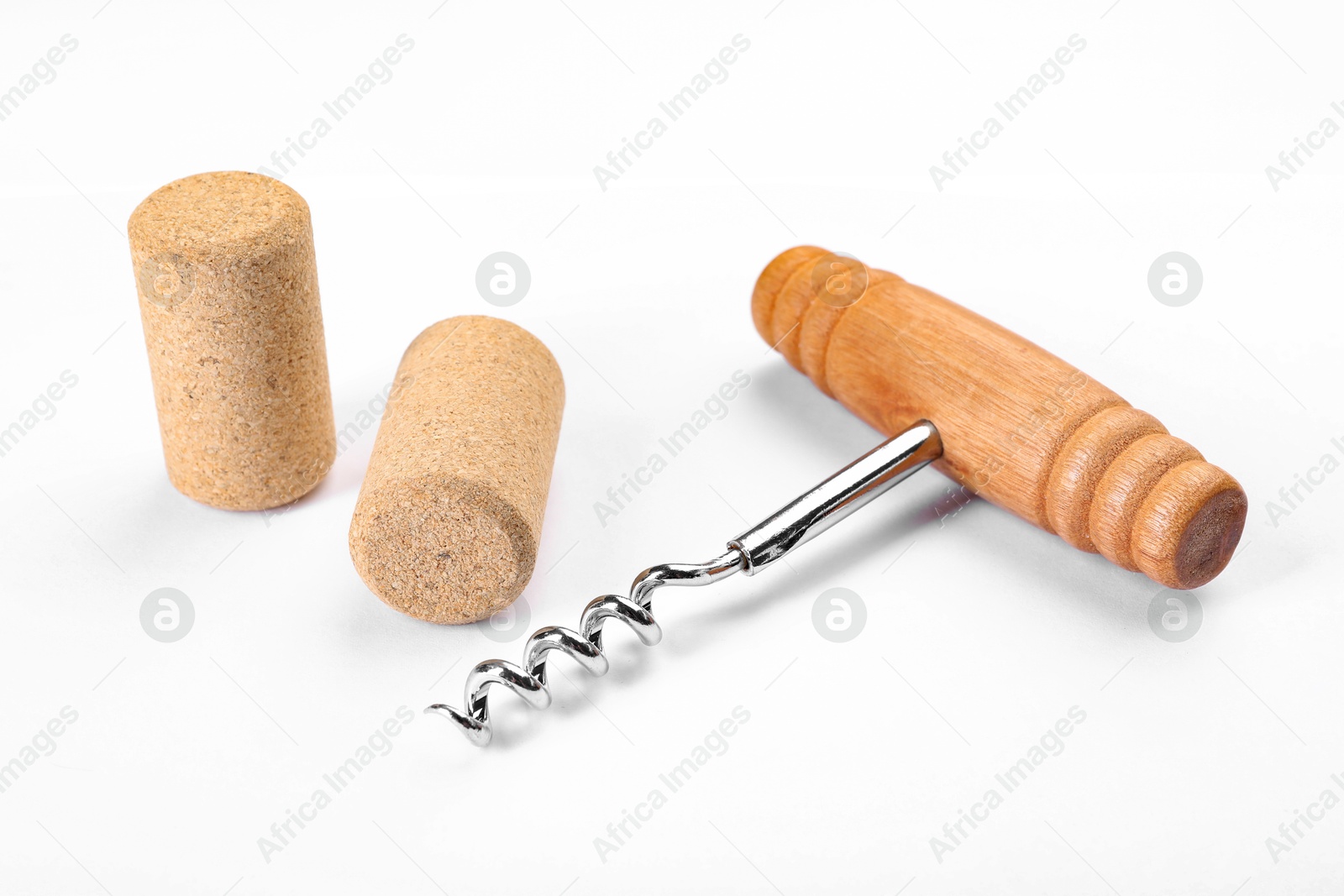 Photo of Corkscrew with wooden handle and corks on white background