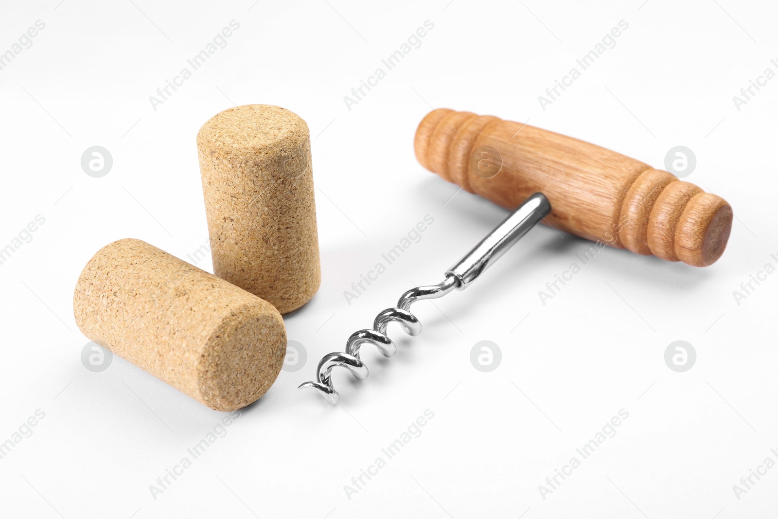 Photo of Corkscrew with wooden handle and corks on white background