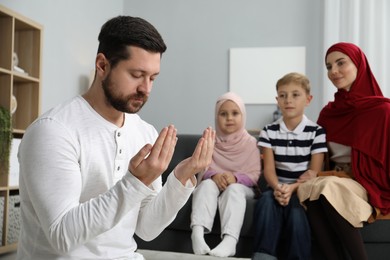 Photo of Happy Muslim family spending time together and praying at home