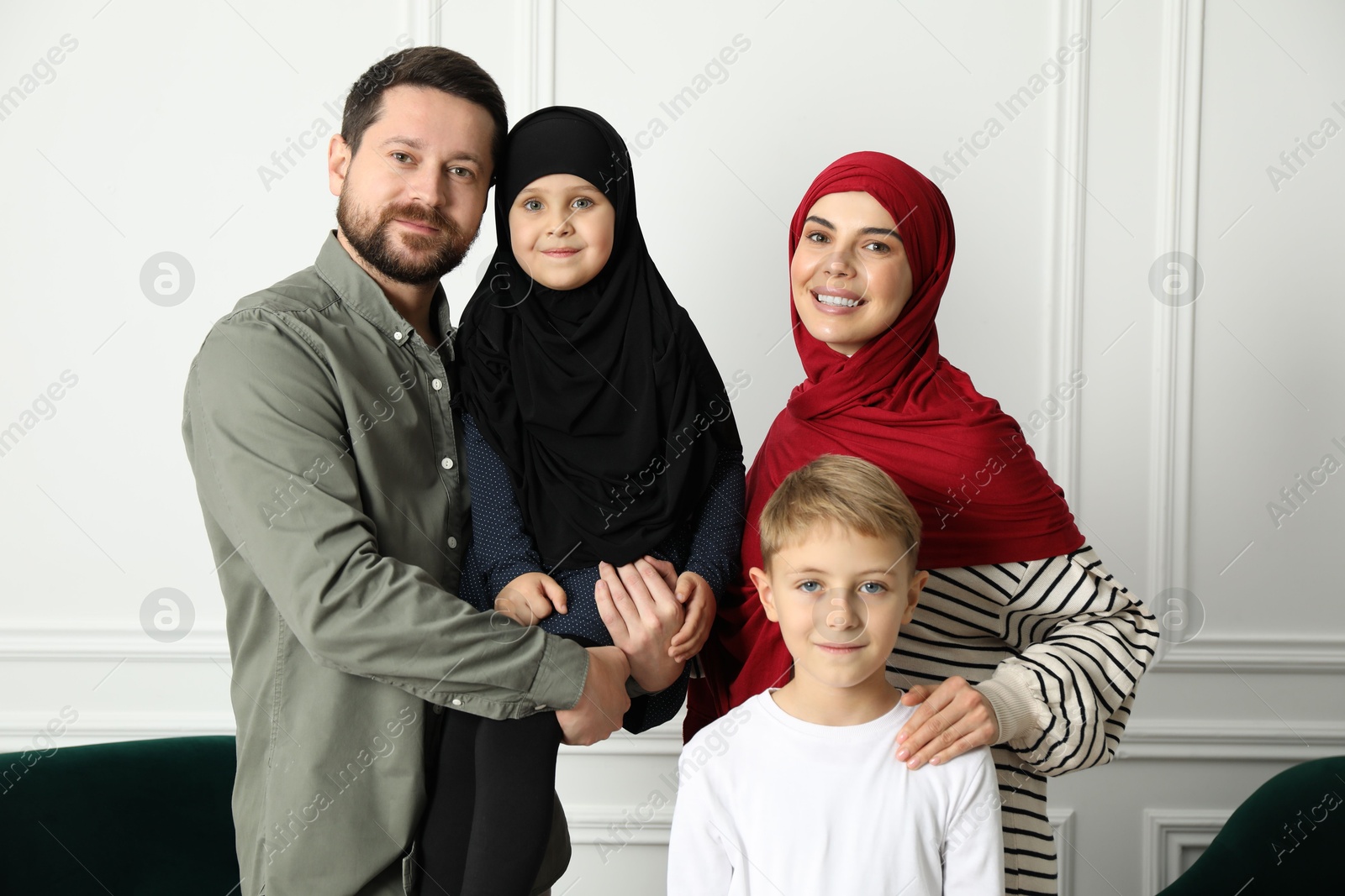 Photo of Happy Muslim family spending time together at home