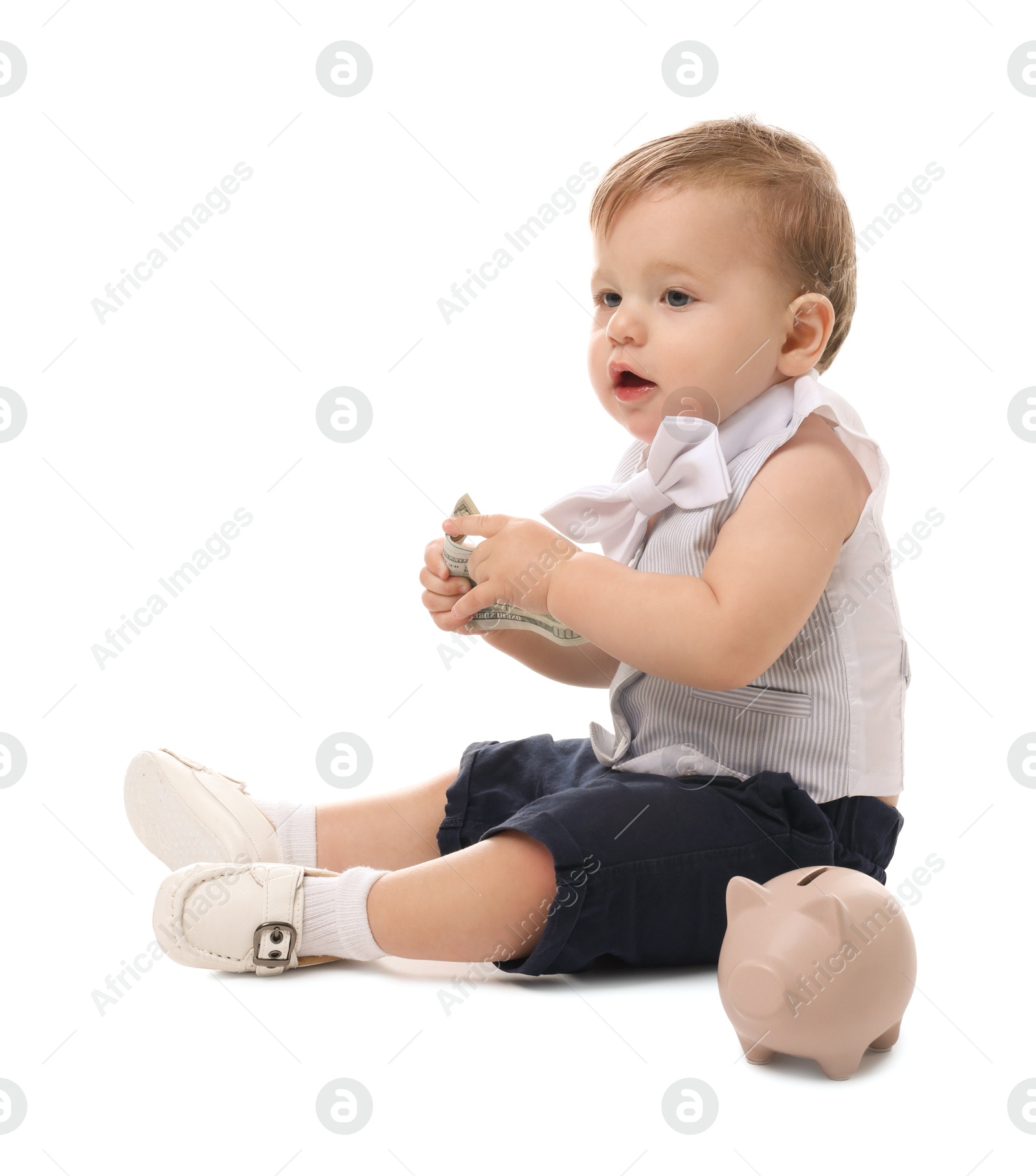 Photo of Little baby with money and piggybank on white background