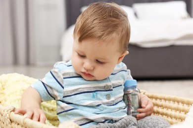 Photo of Little baby with money in bottle at home