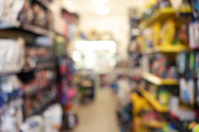 Photo of Blurred view of shelves with different products in pet shop