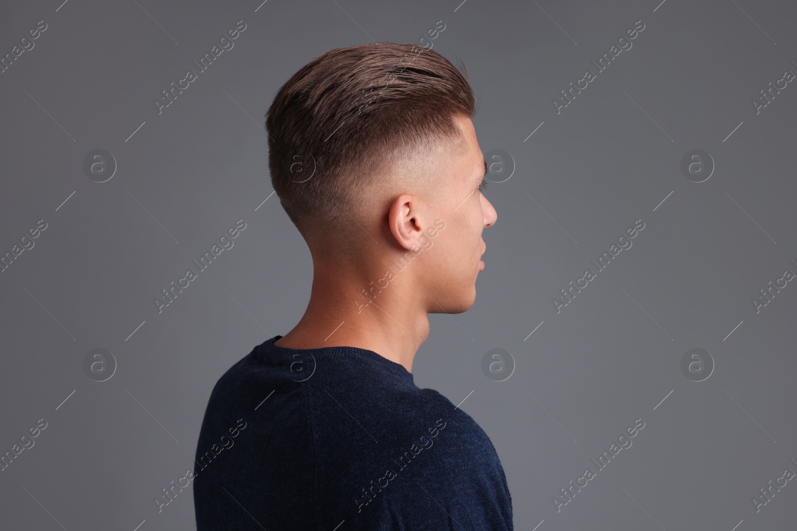 Photo of Man with stylish haircut on grey background