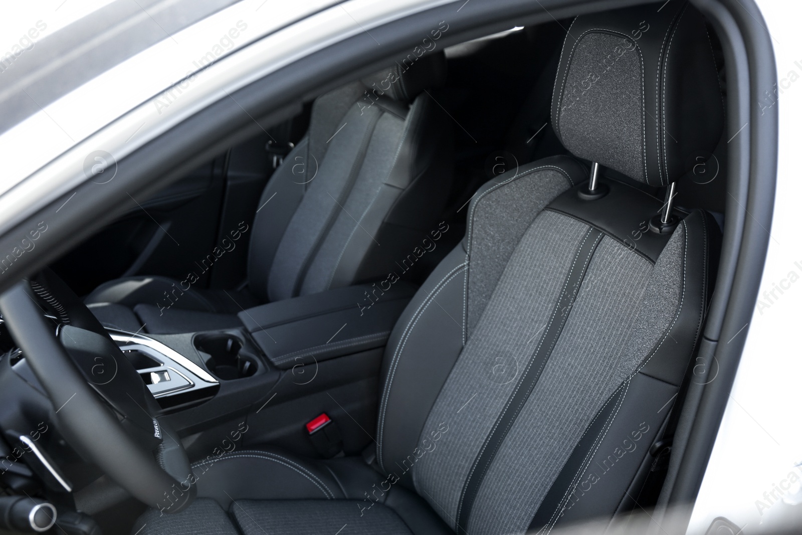 Photo of Comfortable seats inside of modern white car, closeup