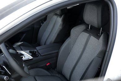 Photo of Comfortable seats inside of modern white car, closeup