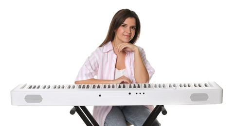 Photo of Beautiful woman posing with synthesizer on white background