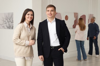 Photo of Happy woman and man visiting art gallery