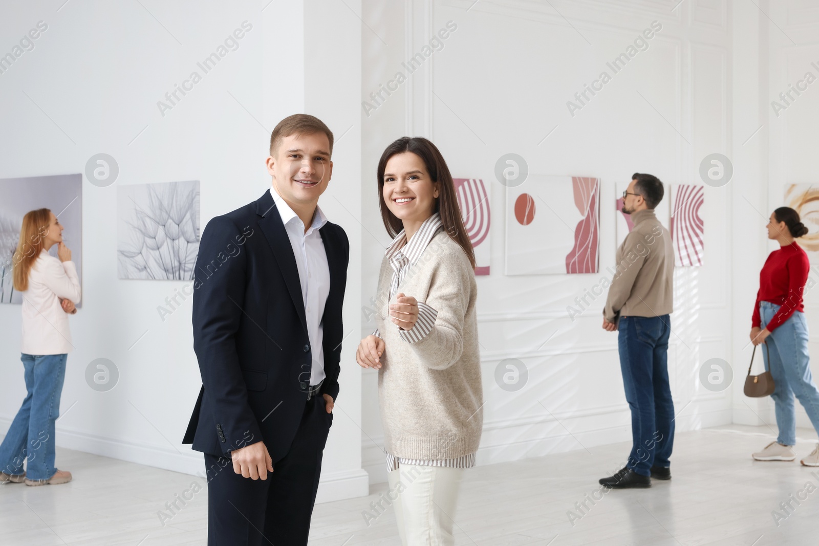 Photo of Happy woman and man visiting art gallery