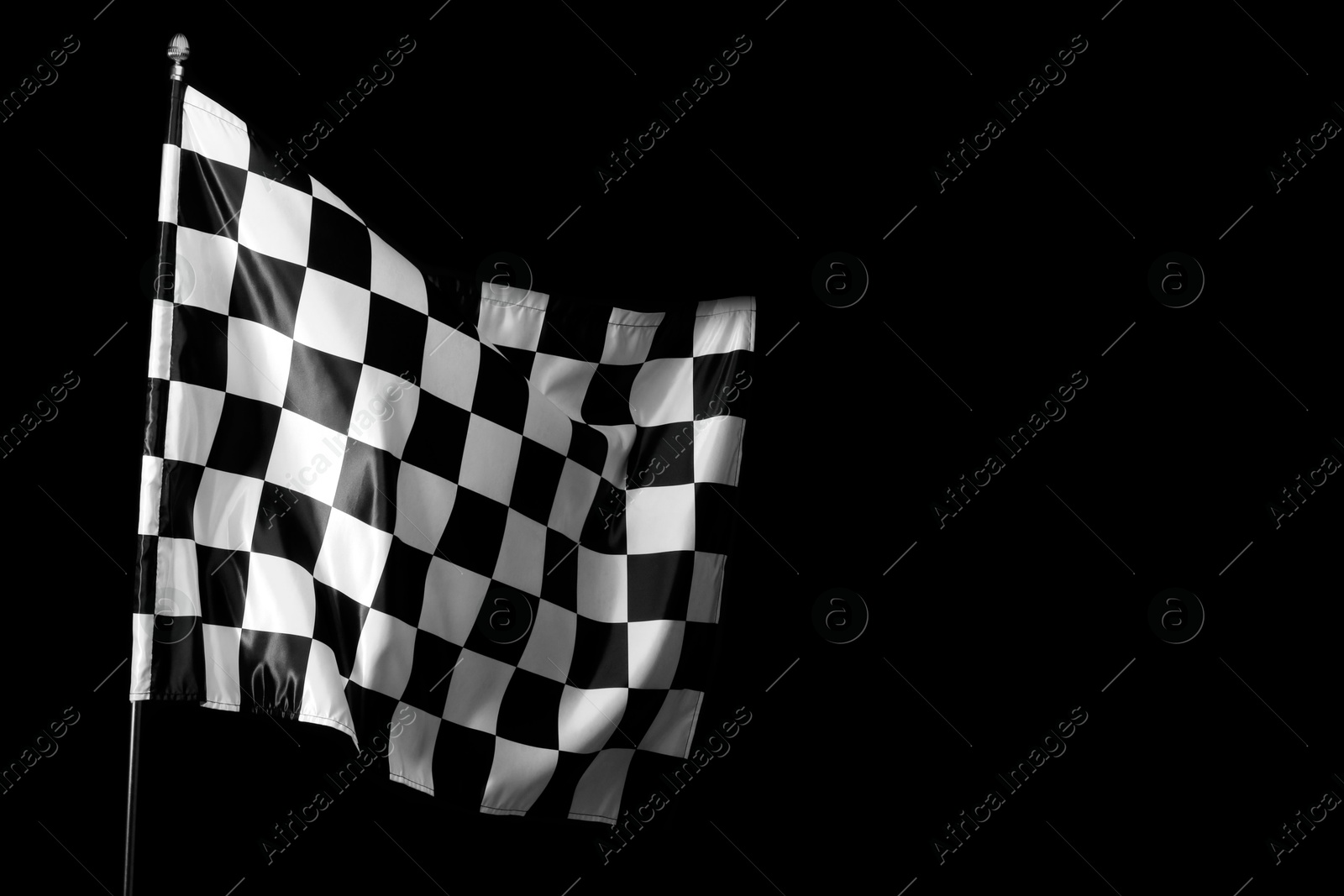 Photo of One racing checkered flag on black background, space for text