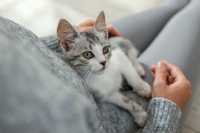 Photo of Woman with cute kitten at home, closeup