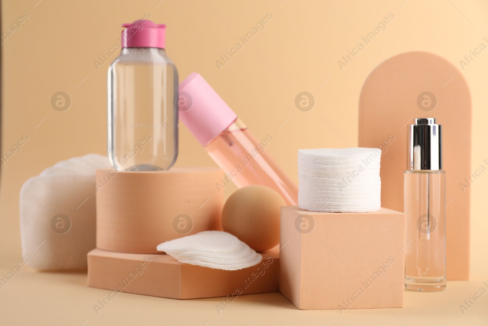 Photo of Clean cotton pads and cosmetic products on beige background