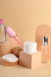 Photo of Clean cotton pads and cosmetic products on beige background