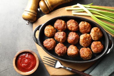 Photo of Tasty meatballs served on grey table, flat lay